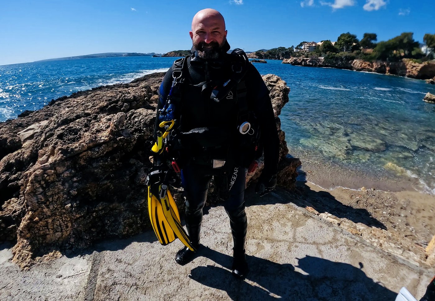 Russ in scuba gear on a rocky Mediterranean shore